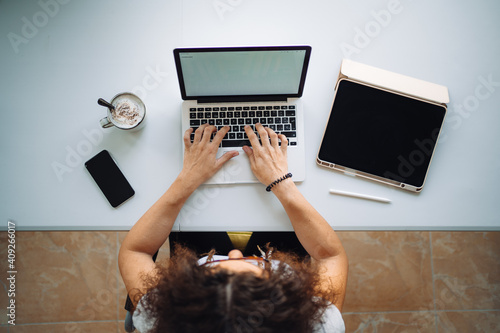 Aerial shot of unrecognizable woman working from home photo