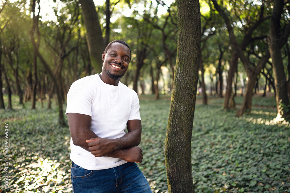 A young black man in park. Outdoor portrait of traveler. A young black man in park. Outdoor portrait of traveler.