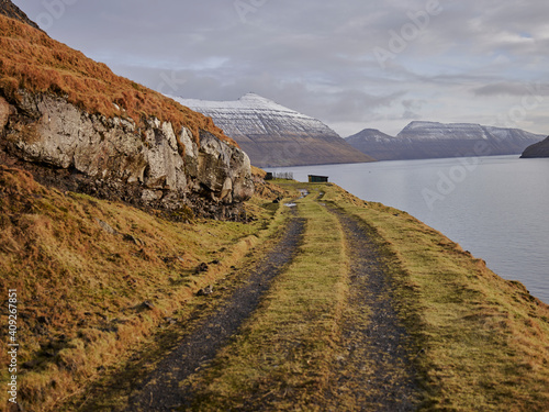 Gravel road along bay in the Faroe Islands photo