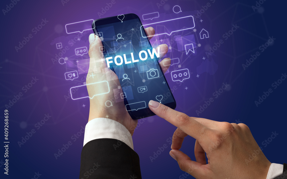 Female hand typing on smartphone with FOLLOW inscription, social media concept Female hand typing on smartphone with FOLLOW inscription, social media concept