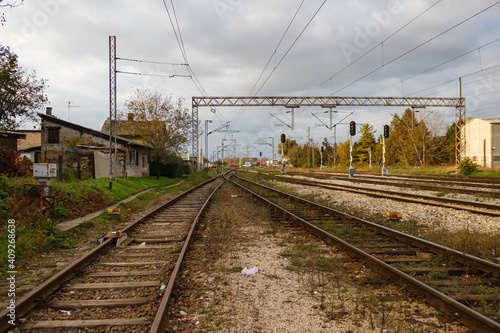 Wide-angle lens shot of a train track under a cloudy sky photo