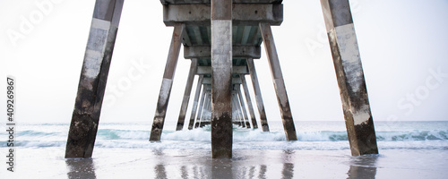 Underneath an ocean pier with symmetrical lines. © Becky Wright