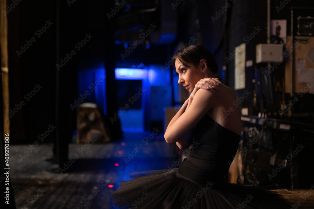 Anxious ballet dancer stretching shoulders Anxious ballet dancer stretching shoulders