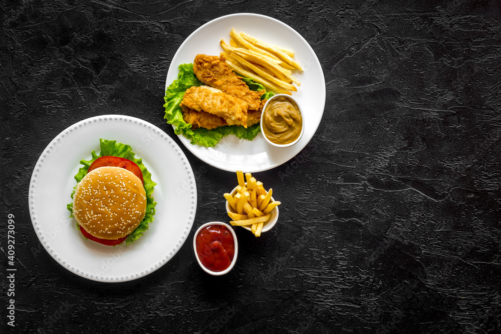 Burger with fried potatoes and chicken, top view Burger with fried potatoes and chicken, top view