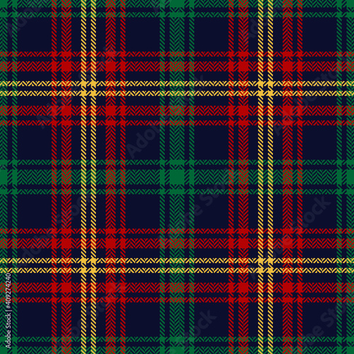 Tartan plaid pattern in red, green, blue, yellow. Textured herringbone seamless dark colorful check for Christmas and New Year blanket, flannel shirt, tablecloth, or other modern winter textile.