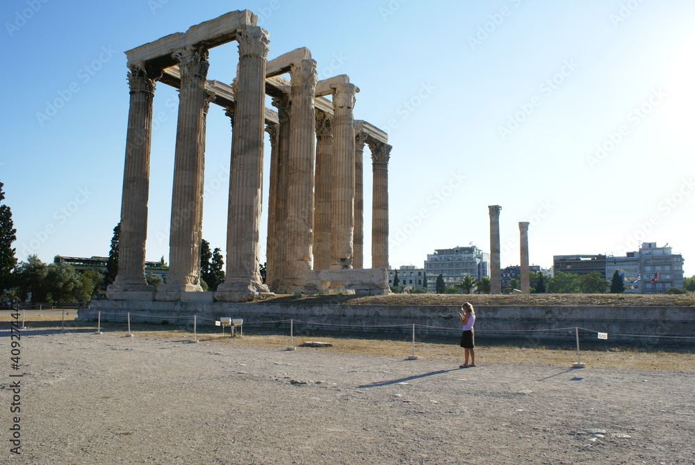 A tourist visiting the ruins of the Temple of Zeus (Olympiaion) in Athens, Greece