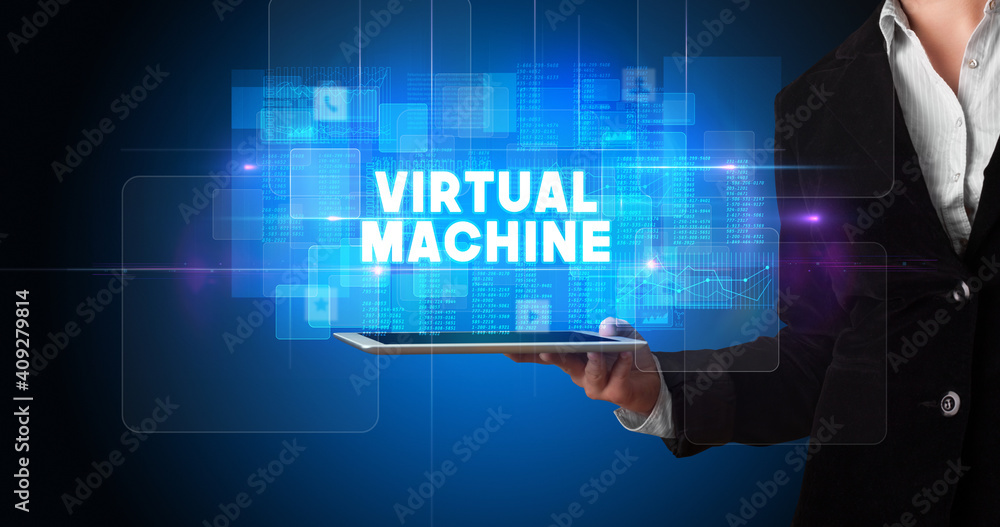 Young business person working on tablet and shows the inscription: VIRTUAL MACHINE Young business person working on tablet and shows the inscription: VIRTUAL MACHINE