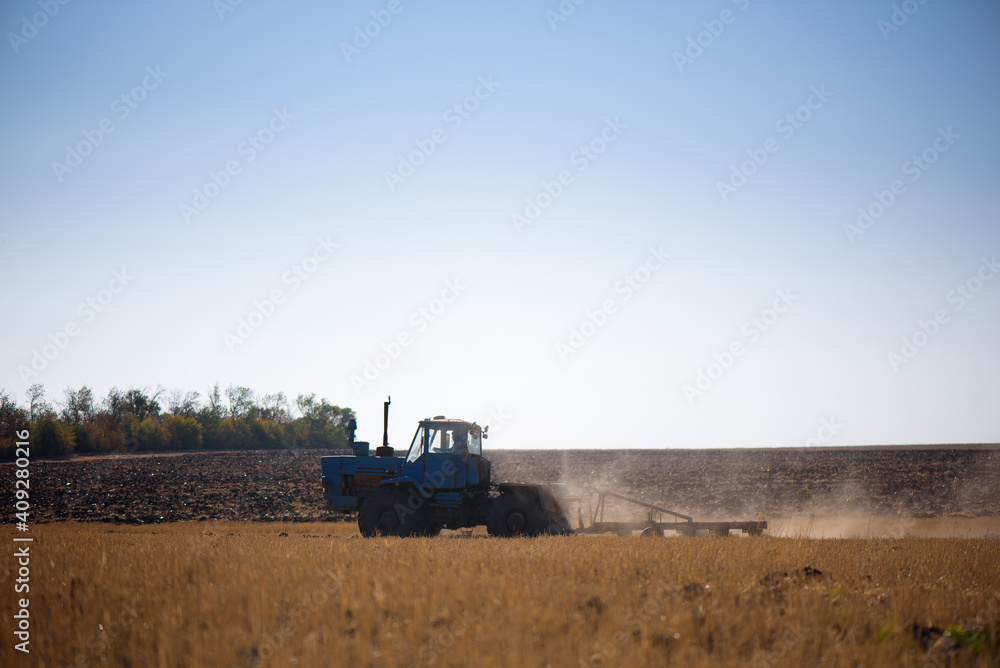 Fototapeta premium Tractor plowing fields -preparing land for sowing