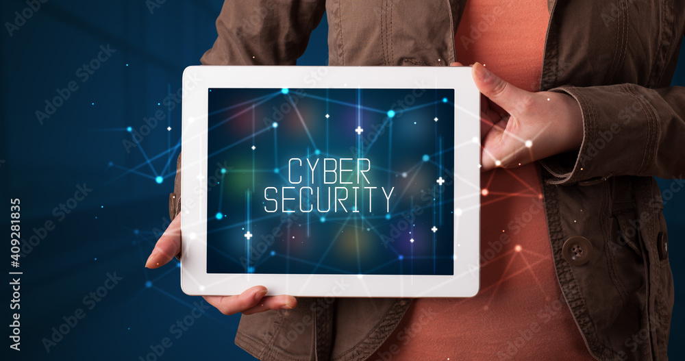 Young business person working on tablet and shows the digital sign: CYBER SECURITY Young business person working on tablet and shows the digital sign: CYBER SECURITY