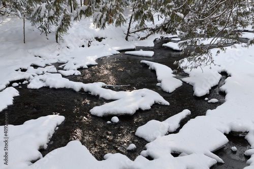 Fresh snow on rapids of Hewitts Creek after a snowstorm along Wilkins Walk Barrie Canada photo
