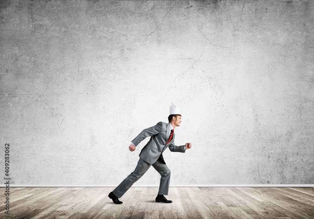 King businessman in elegant suit running in empty room King businessman in elegant suit running in empty room