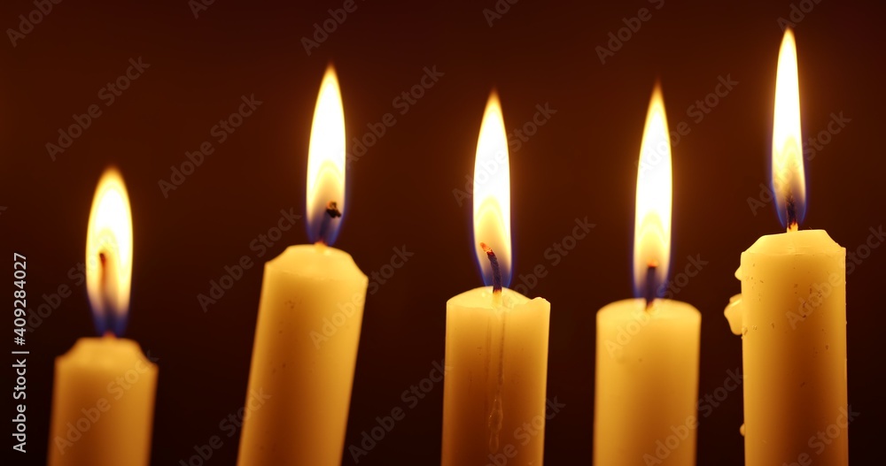 Candles glowing against dark background Candles glowing against dark background