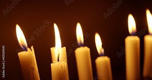 Candles glowing against dark background