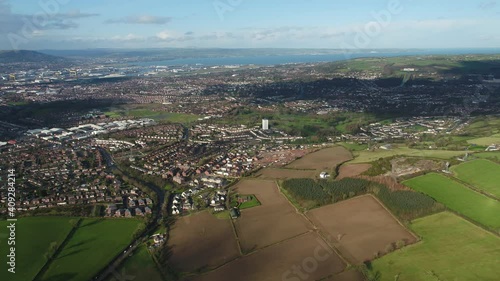 Aerial flyover of east Belfast from the countryside looking towards the city centre or center