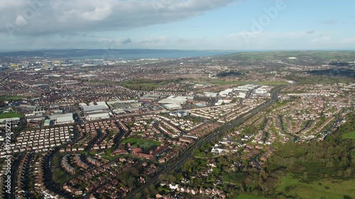 Aerial flyover of east Belfast from the countryside looking towards the city centre or center