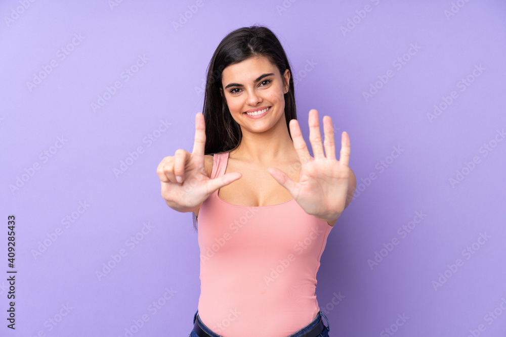 Young woman over isolated purple background counting seven with fingers Young woman over isolated purple background counting seven with fingers