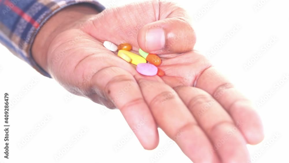 many colorful pills and capsule on palm of hand isolated on white many colorful pills and capsule on palm of hand isolated on white
