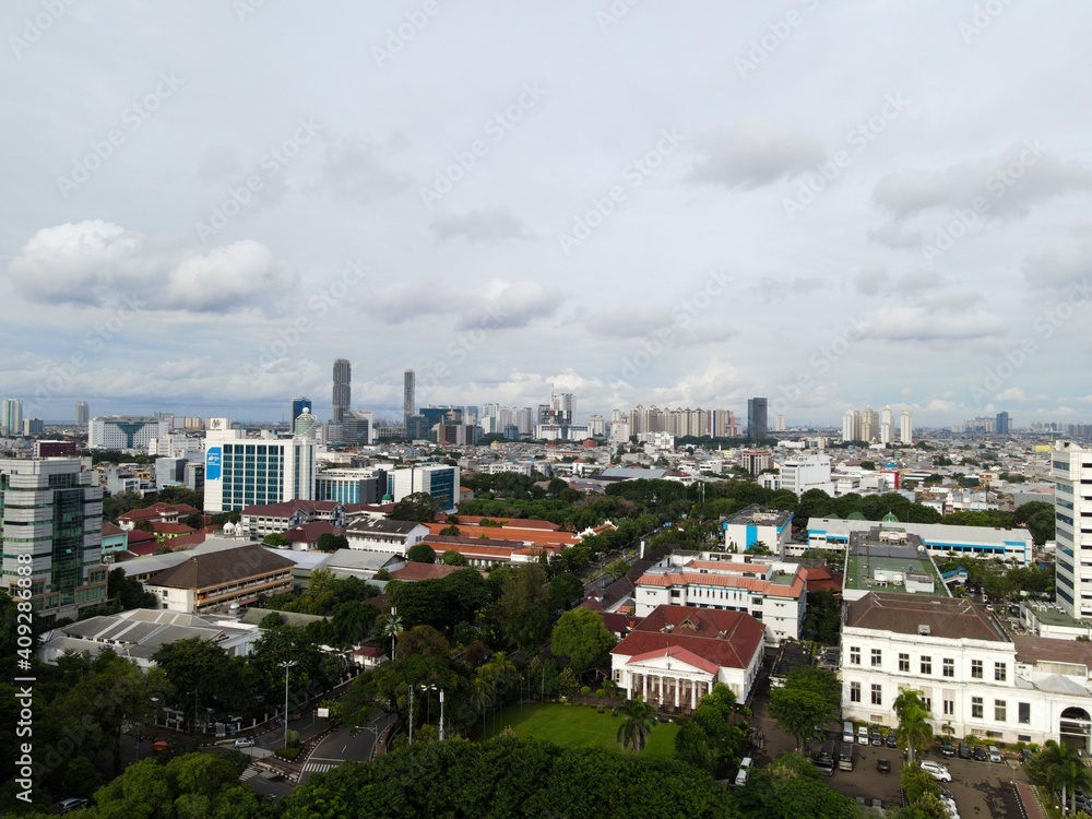 Fototapeta premium Aerial view of highway intersection and buildings in the city of Jakarta and noise cloud with Jakarta cityscape. JAKARTA - Indonesia. January 30, 2021