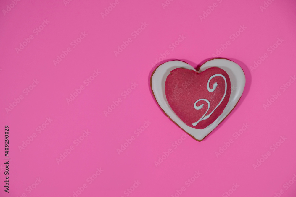 Festive ginger heart on pink. Valentine's day. Minimalism. Copy space. Top view. 