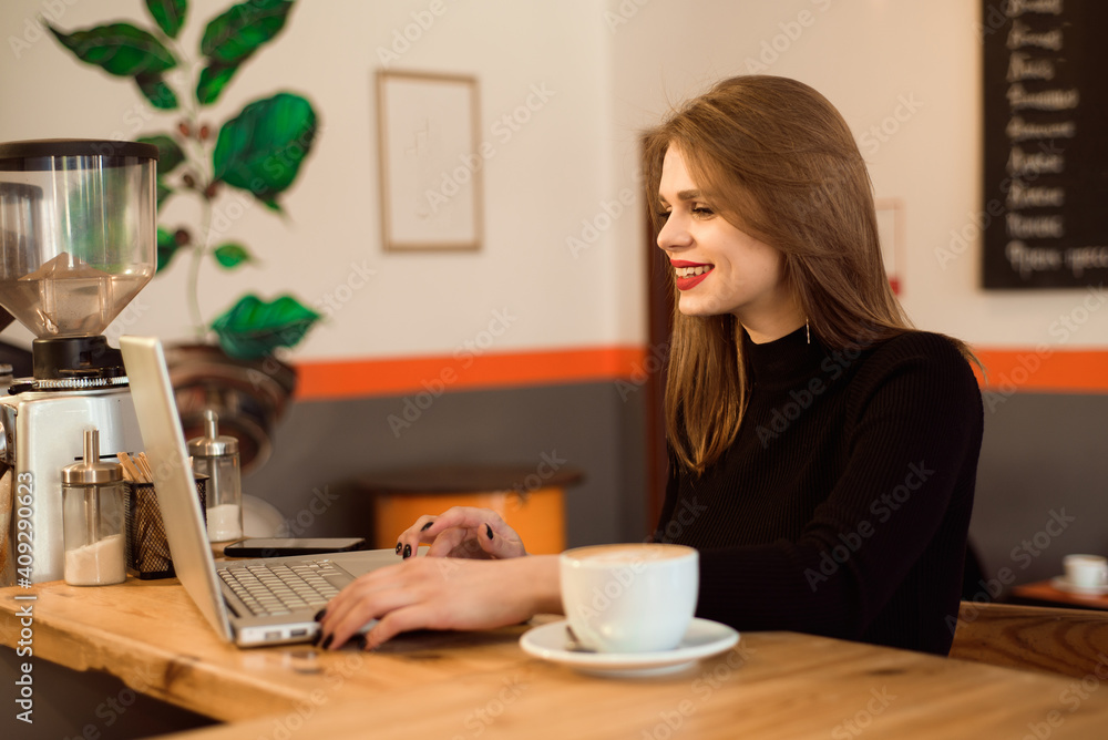 Beautiful Caucasian woman dreaming about something while sitting with portable net-book in modern cafe bar. Beautiful Caucasian woman dreaming about something while sitting with portable net-book in modern cafe bar.