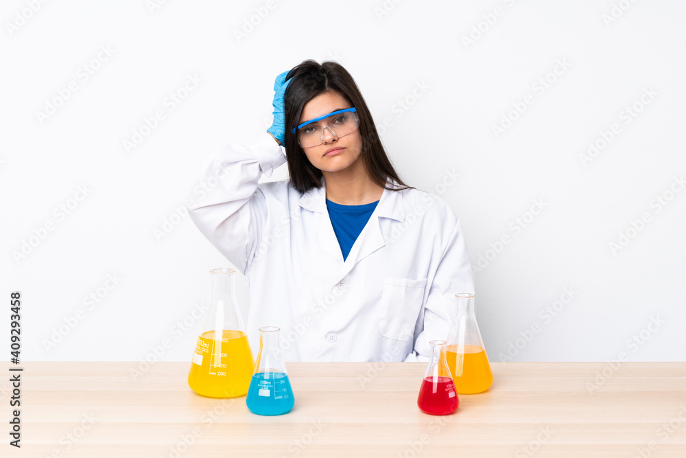 Young scientific woman in a table with an expression of frustration and not understanding Young scientific woman in a table with an expression of frustration and not understanding