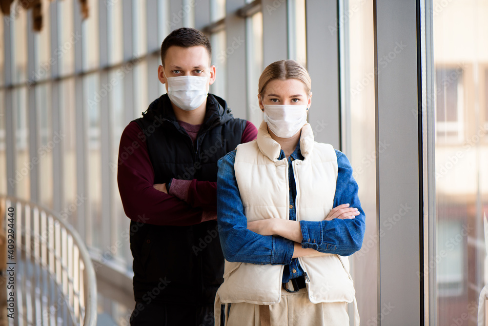 Man and woman wearing protective mask against transmissible infectious diseases and as protection against the flu. New coronavirus 2019-nCoV from China. Man and woman wearing protective mask against transmissible infectious diseases and as protection against the flu. New coronavirus 2019-nCoV from China.