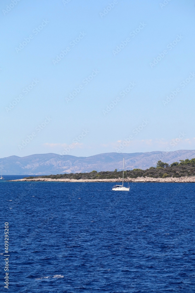 Obraz premium Sailing boat near island in Croatia. Beautiful Mediterranean landscape.