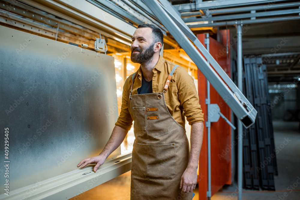 Worker checking the quality of the painted with powder coating metal products Worker checking the quality of the painted with powder coating metal products