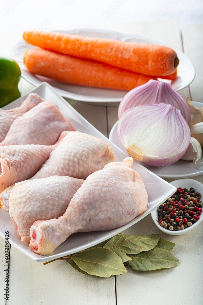Raw chicken legs with vegetables for cooking Raw chicken legs with vegetables for cooking