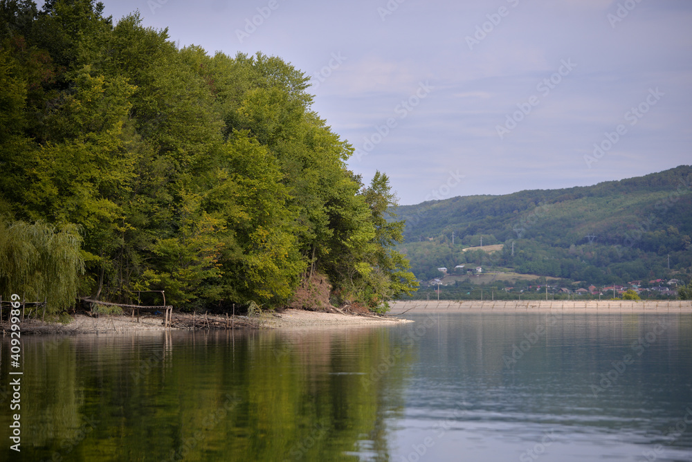 green forest reflecting in the luster of the lake green forest reflecting in the luster of the lake