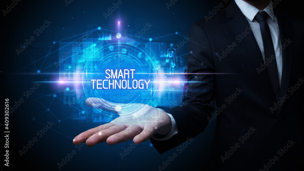 Man hand holding SMART TECHNOLOGY inscription, technology concept Man hand holding SMART TECHNOLOGY inscription, technology concept