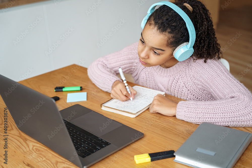 Portrait of teen student studying online on her laptop at home. Portrait of teen student studying online on her laptop at home.