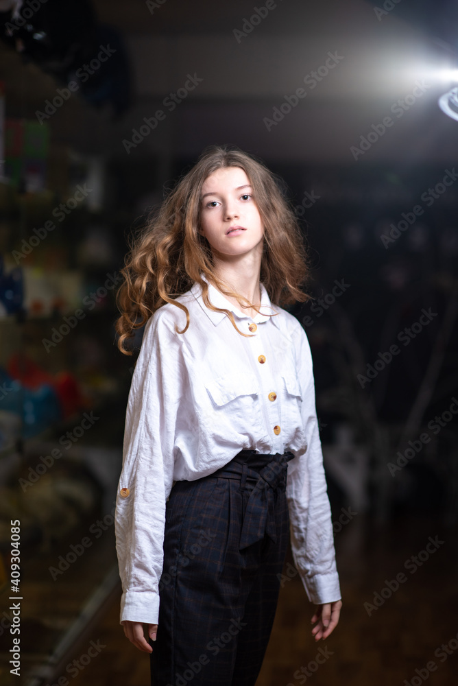 Portrait of a young beautiful girl of model appearance on a dark background. Portrait of a young beautiful girl of model appearance on a dark background.