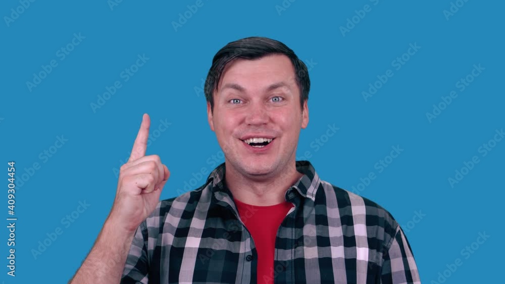 Portrait of happy man pointing fingers up at copy space, isolated on blue background. Idea. Portrait of happy man pointing fingers up at copy space, isolated on blue background. Idea.