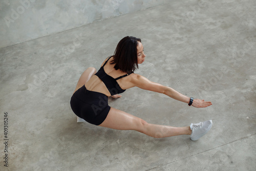 A woman in a sporty image on a fitness workout. She has been stretching