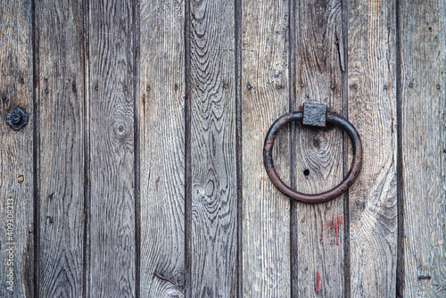 Fotografie old wooden door with lock,  fragment of a vintage wooden door with an iron ring,