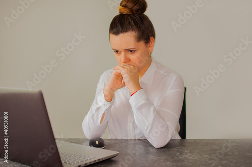Office worker girl thinks over the project