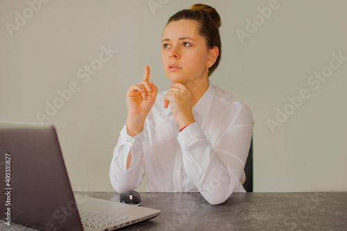Office worker girl thinks over the project