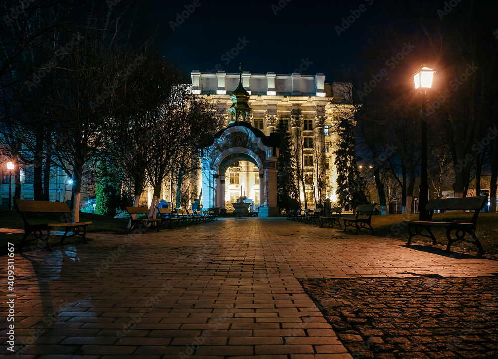 Chapel in the park near the St. Michael's Golden Gate Cathedral and park at night. A cobbled path and benches near the St. Michael's Golden Gate Cathedra. Kyiv, Ukraine