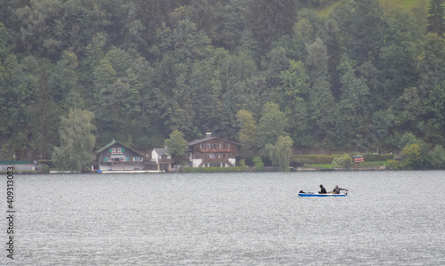 two fisher men in a boat on the lake Zell in the european alps of Austria