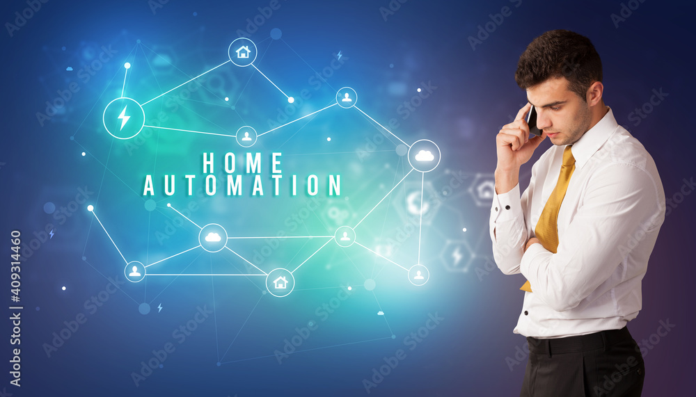 Businessman in front of cloud service icons with HOME AUTOMATION inscription, modern technology concept Businessman in front of cloud service icons with HOME AUTOMATION inscription, modern technology concept