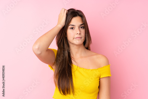 Teenager Brazilian girl over isolated pink background with an expression of frustration and not understanding