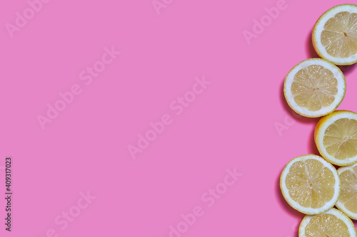 Lemon slices on a pink background. CITRUS CITRIC