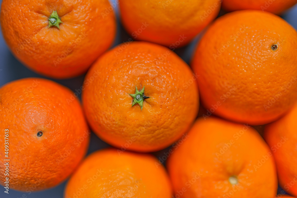 Oranges with skin seen close up on gray background. CITRUS CITRIC Oranges with skin seen close up on gray background. CITRUS CITRIC