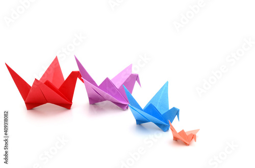 A follow teamwork origami birds on white