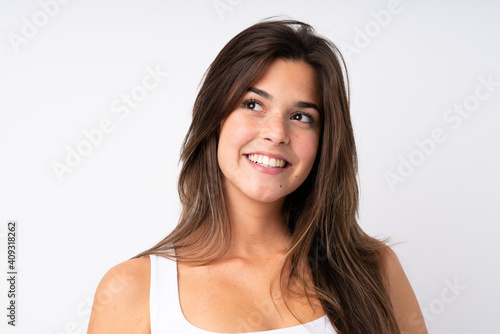 Portrait of pretty teenager Brazilian girl over isolated background