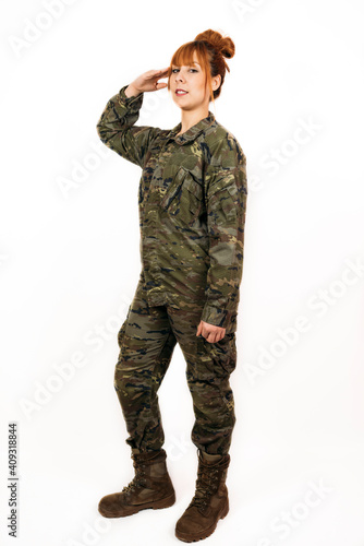 Woman wearing military uniform giving a military hand salute with a smile