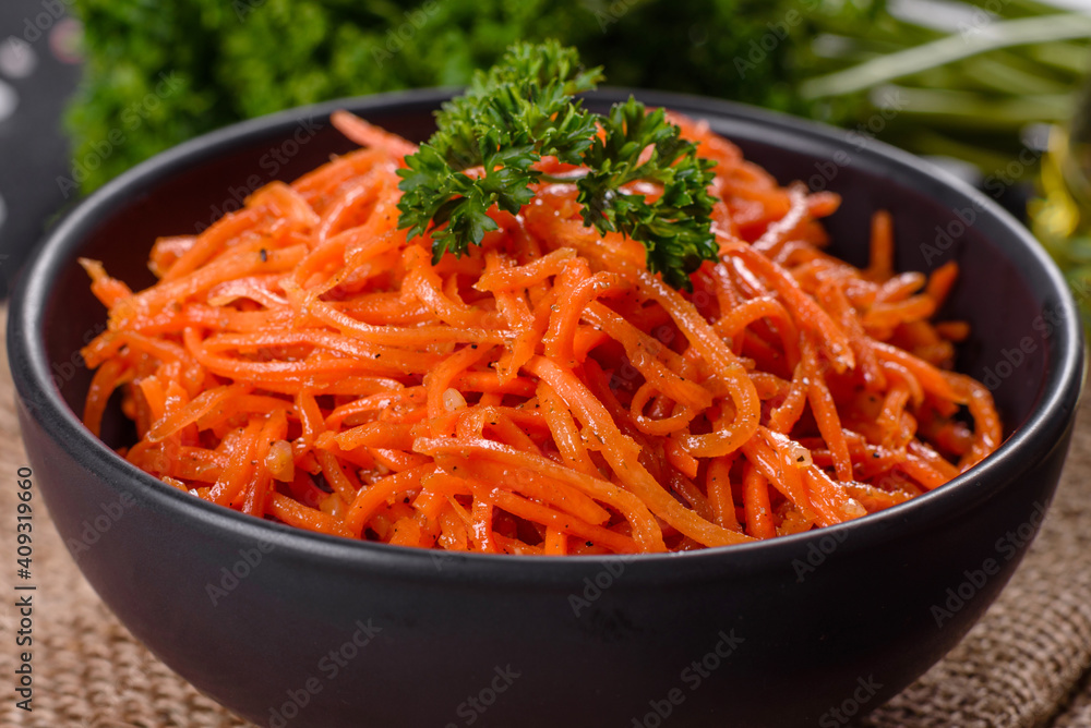Delicious spicy juicy bright Korean carrots in ceramic dishes Delicious spicy juicy bright Korean carrots in ceramic dishes
