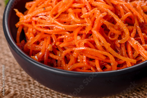 Delicious spicy juicy bright Korean carrots in ceramic dishes