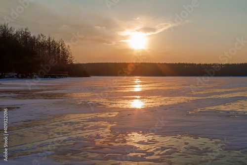 Sunset on ice  a frozen lake in winter.